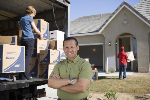 Storage facility staff separating recyclable boxes and packing materials
